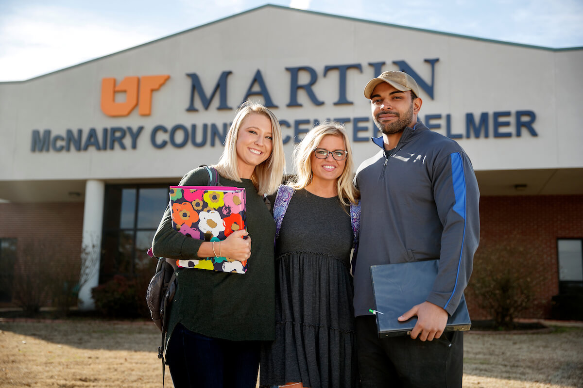 Students standing in front of the Selmer Center sign.